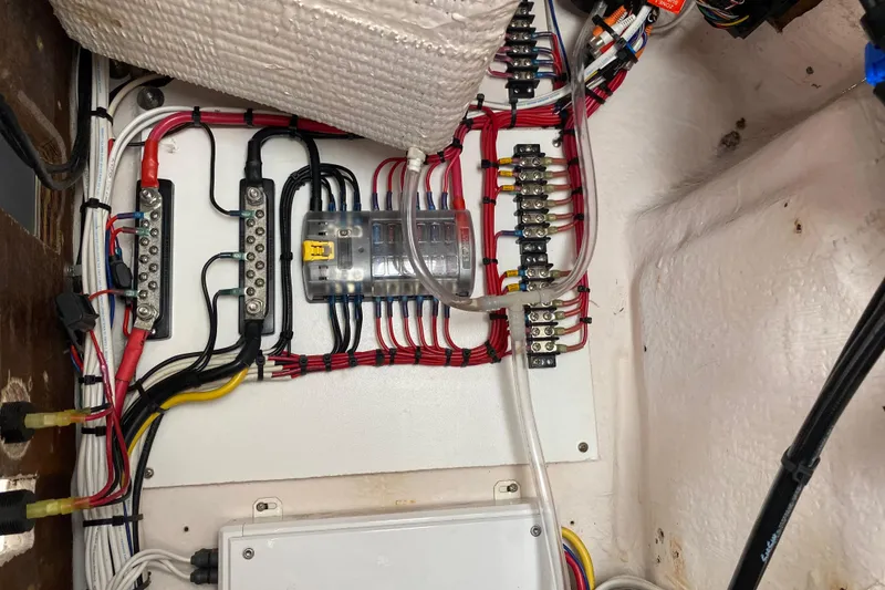 Slide: The Image of Electrical wiring setup in a 2004 Grady-White Canyon 283 boat, showcasing organized connections. - 63