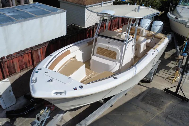 Slide: The Image of 2004 Grady-White Canyon 283 boat on trailer, featuring spacious deck and dual engines. - 7