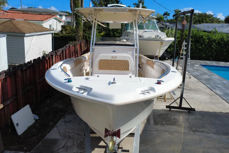 Slide: The Image of 2004 Grady-White Canyon 283 boat on trailer, parked near pool and houses. - 8