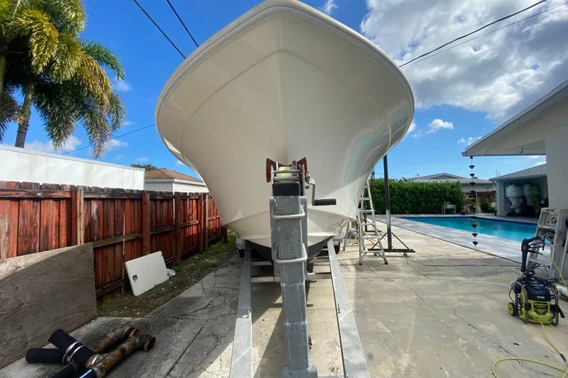 Slide: The Image of 2004 Grady-White Canyon 283 boat on trailer, near pool and palm trees. - 9