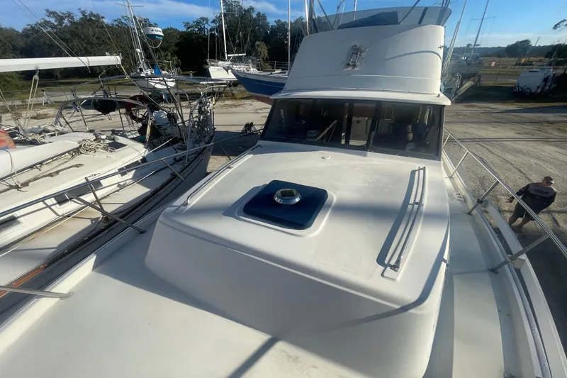 Slide: The Image of 1986 Mainship Mark III Motor Cruiser docked among other boats in a marina. - 10