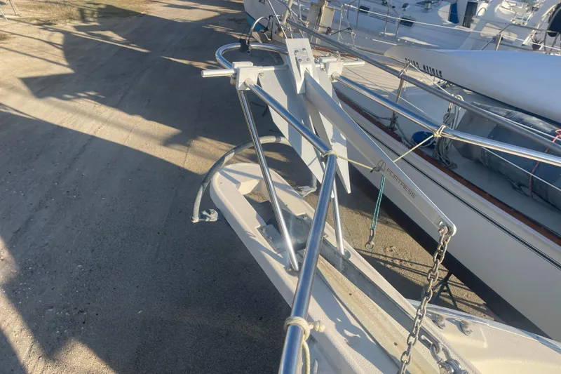 Slide: The Image of 1986 Mainship Mark III Motor Cruiser with anchor on deck, docked in a marina. - 14