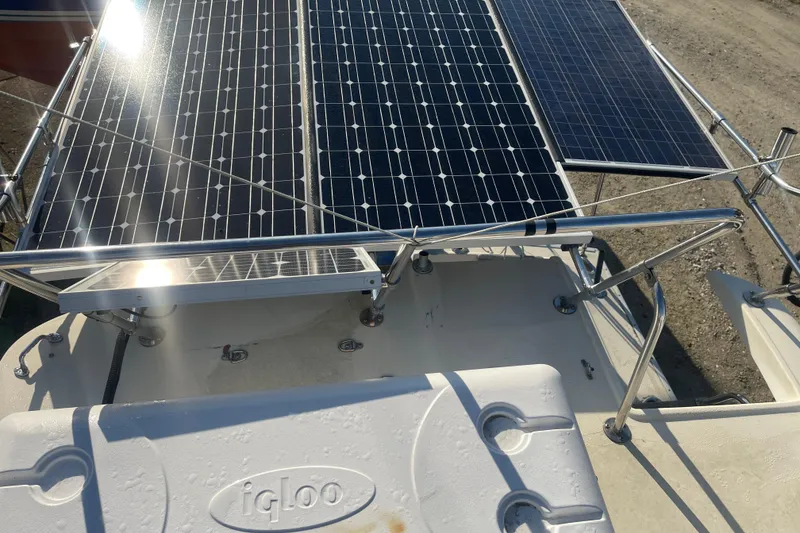 Slide: The Image of 1986 Mainship Mark III Motor Cruiser with solar panels and Igloo cooler on deck. - 18