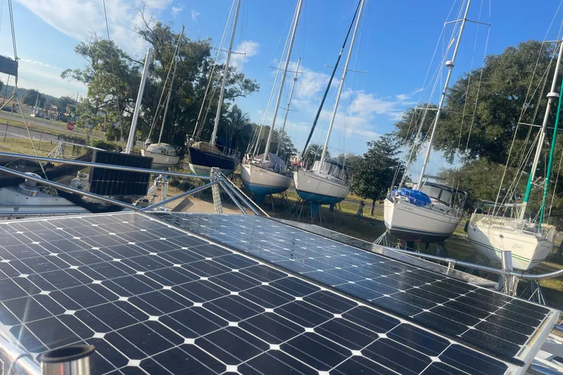 Slide: The Image of Solar panels on a 1986 Mainship Mark III Motor Cruiser with sailboats in the background. - 19