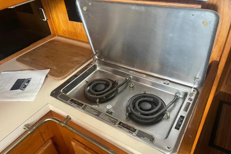 Slide: The Image of 1986 Mainship Mark III Motor Cruiser stove in wooden kitchen area. - 22
