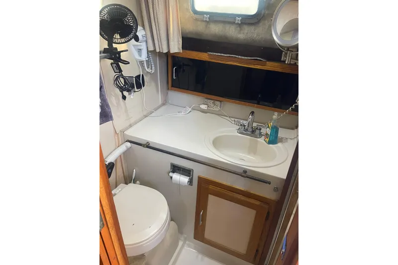 Slide: The Image of 1986 Mainship Mark III Motor Cruiser bathroom with sink, toilet, and mirror. - 28