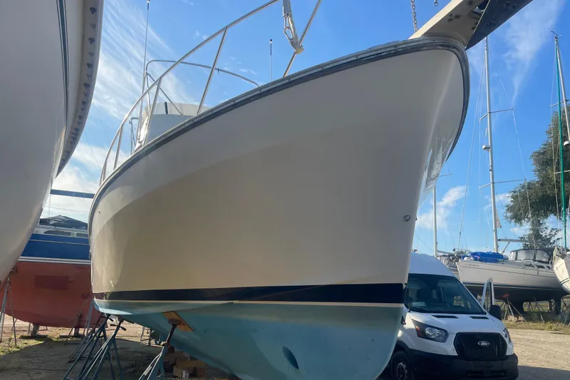 Slide: The Image of 1986 Mainship Mark III Motor Cruiser on dry dock, clear sky background. - 3