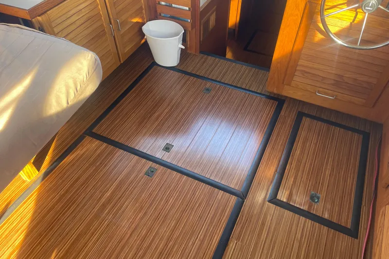 Slide: The Image of 1986 Mainship Mark III Motor Cruiser interior with wood flooring and steering wheel. - 33