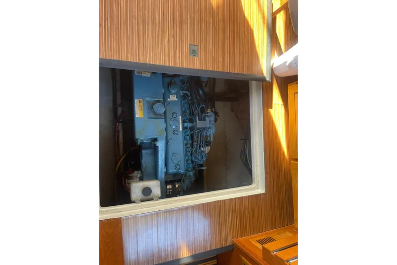 Slide: The Image of 1986 Mainship Mark III Motor Cruiser engine compartment with visible blue machinery. - 36