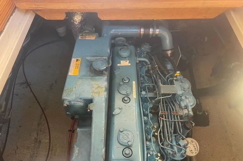 Slide: The Image of Engine compartment of 1986 Mainship Mark III Motor Cruiser, showcasing detailed mechanical components. - 37