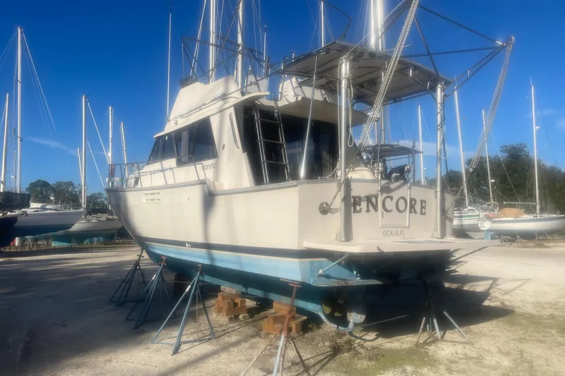 Slide: The Image of 1986 Mainship Mark III Motor Cruiser on stands, sunny day, marina background. - 4