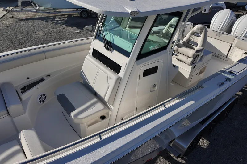 Slide: The Image of 2026 Sailfish 312 CC boat interior with seating and console, showcasing modern design. - 11