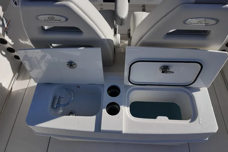 Slide: The Image of 2026 Sailfish 312 CC boat interior with open storage compartments and cup holders. - 16