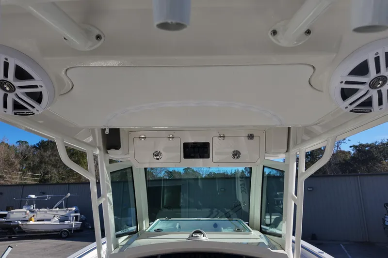Slide: The Image of 2026 Sailfish 312 CC boat interior with speakers and storage compartments. - 18