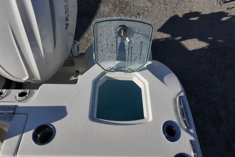 Slide: The Image of 2026 Sailfish 312 CC boat with open livewell and Yamaha engine. - 21