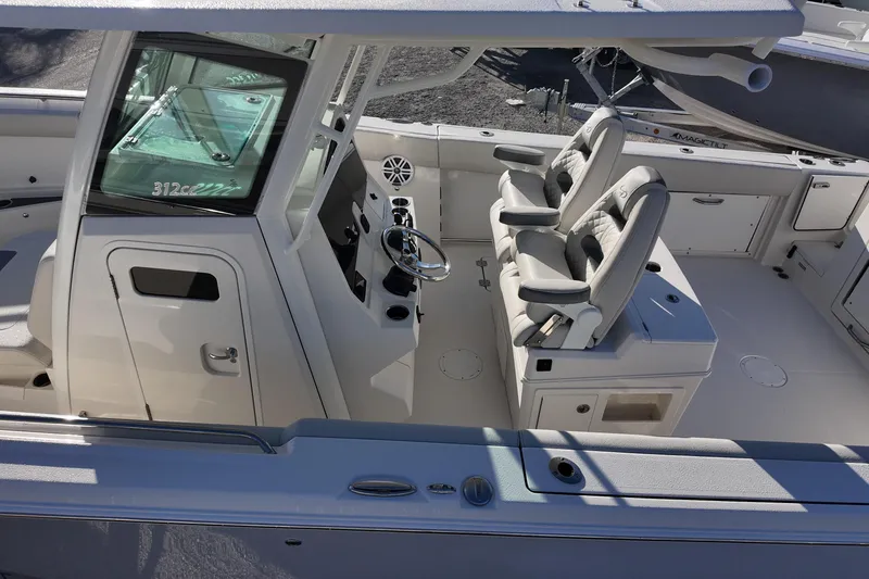 Slide: The Image of 2026 Sailfish 312 CC boat interior with dual captain's chairs and modern helm. - 6