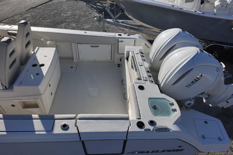 Slide: The Image of 2026 Sailfish 312 CC boat with dual Yamaha engines, spacious deck, and seating area. - 7