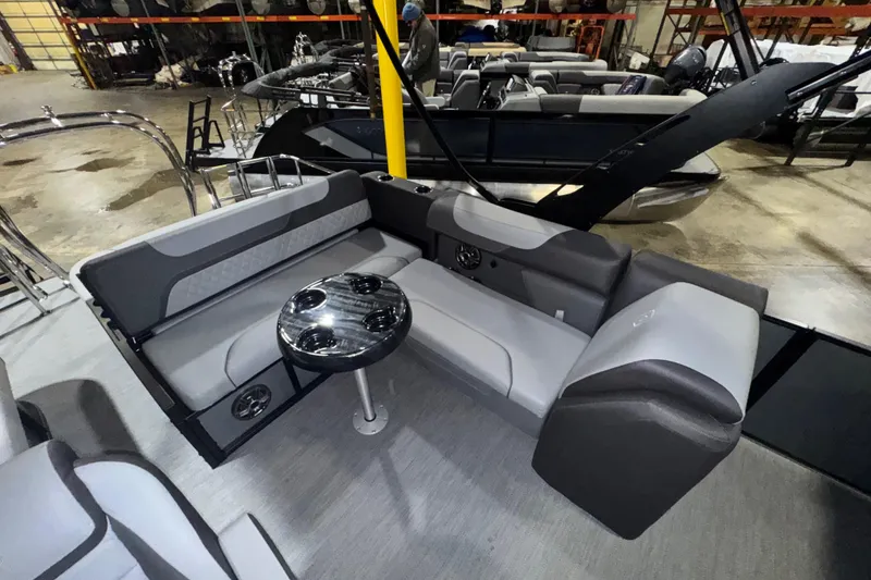 Slide: The Image of 2026 Godfrey Sweetwater 2286 SFL pontoon boat interior with gray seating and round table. - 11