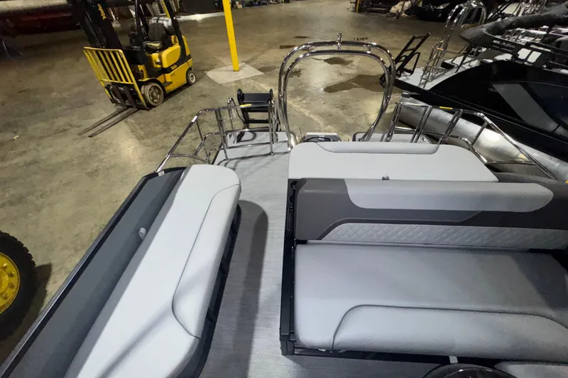 Slide: The Image of 2026 Godfrey Sweetwater 2286 SFL pontoon boat interior with seating, in a warehouse setting. - 12
