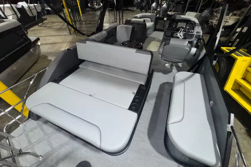 Slide: The Image of 2026 Godfrey Sweetwater 2286 SFL pontoon boat interior with gray seating and steering console. - 14