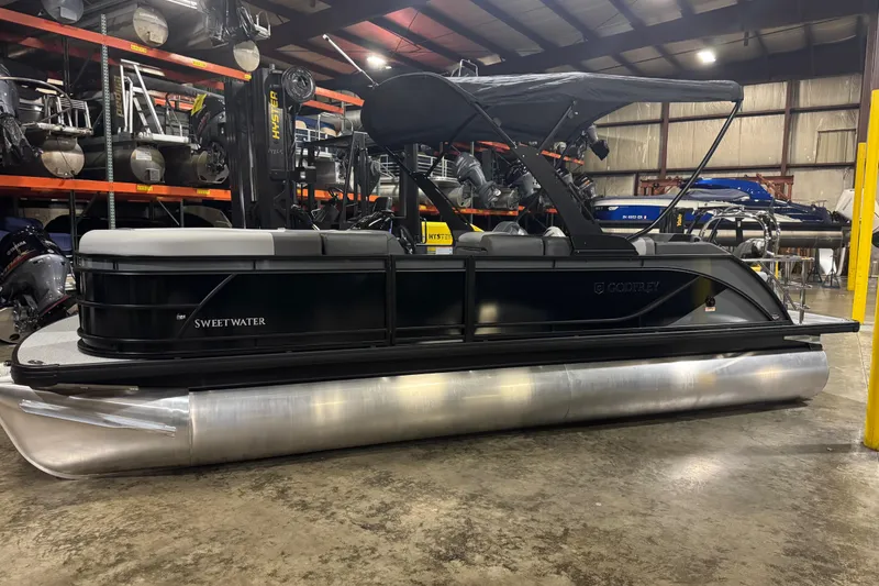 Slide: The Image of 2026 Godfrey Sweetwater 2286 SFL pontoon boat in warehouse setting. - 2