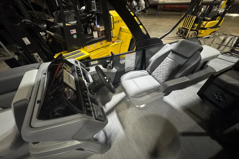 Slide: The Image of 2026 Godfrey Sweetwater 2286 SFL boat interior with modern steering console and luxurious seating. - 8