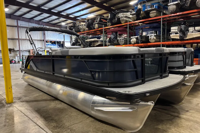 The Image of 2026 Godfrey Sweetwater 2286 SFL pontoon boat in a storage facility. - 0