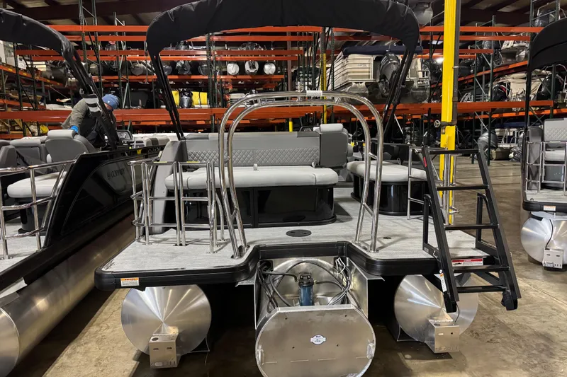 Slide: The Image of 2026 Godfrey Sweetwater 2286 SFL pontoon boat in warehouse, rear view with seating and ladder. - 12