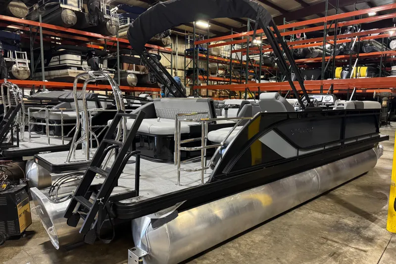 Slide: The Image of 2026 Godfrey Sweetwater 2286 SFL pontoon boat in warehouse, featuring sleek design and spacious seating. - 2