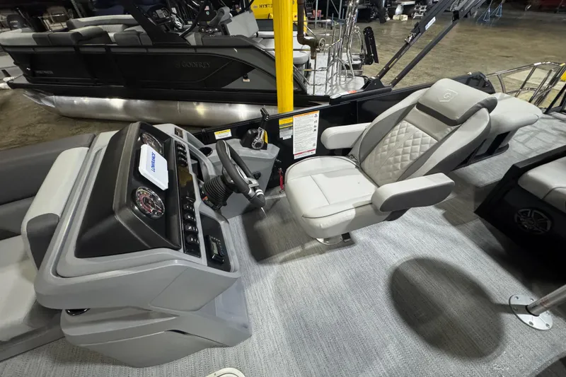 Slide: The Image of 2026 Godfrey Sweetwater 2286 SFL boat interior with steering console and luxurious seating. - 6