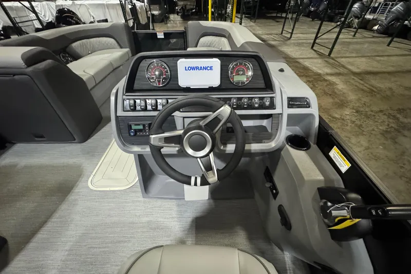Slide: The Image of 2026 Godfrey Sweetwater 2286 SFL boat interior with steering wheel and control panel. - 7