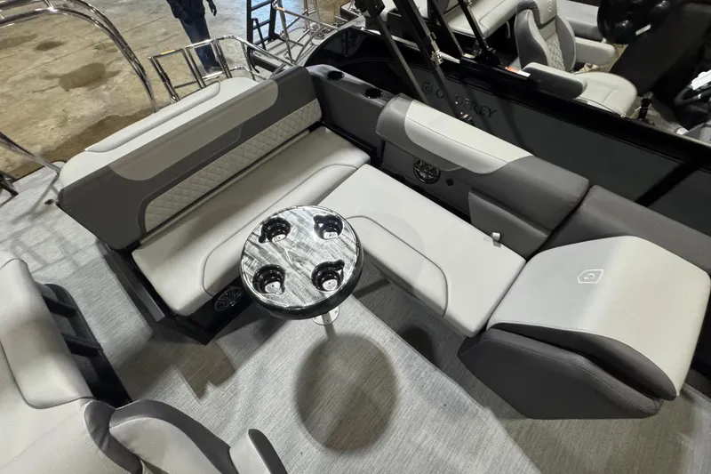 Slide: The Image of 2026 Godfrey Sweetwater 2286 SFL pontoon boat interior with plush seating and cupholder table. - 8