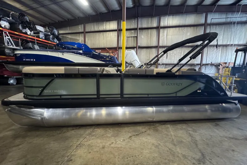 The Image of 2026 Godfrey Sweetwater 2286 SFL pontoon boat in warehouse setting. - 0