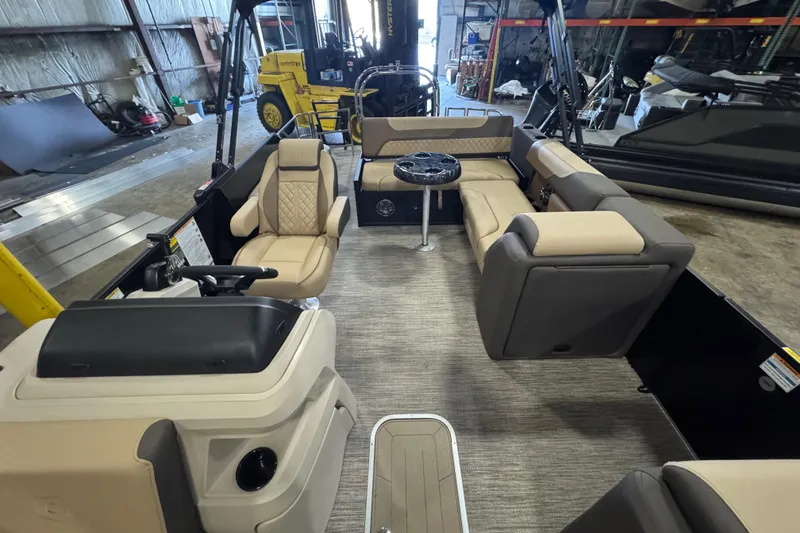 Slide: The Image of 2026 Godfrey Sweetwater 2286 SFL pontoon boat interior with beige seating and steering console. - 5