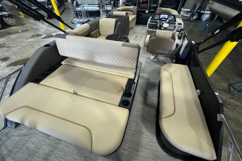 Slide: The Image of 2026 Godfrey Sweetwater 2286 SFL pontoon boat interior with beige seating and modern dashboard. - 9