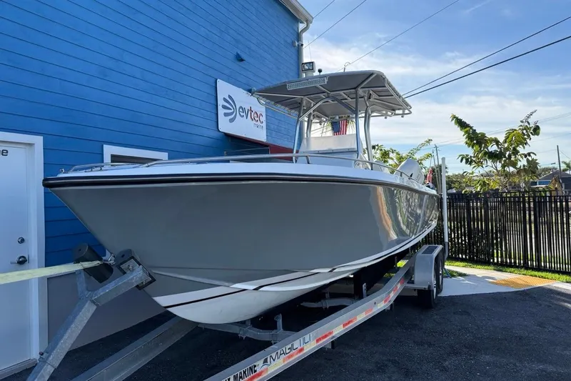 Slide: The Image of 2002 Monza 26 boat on trailer outside blue building, sunny day. - 0