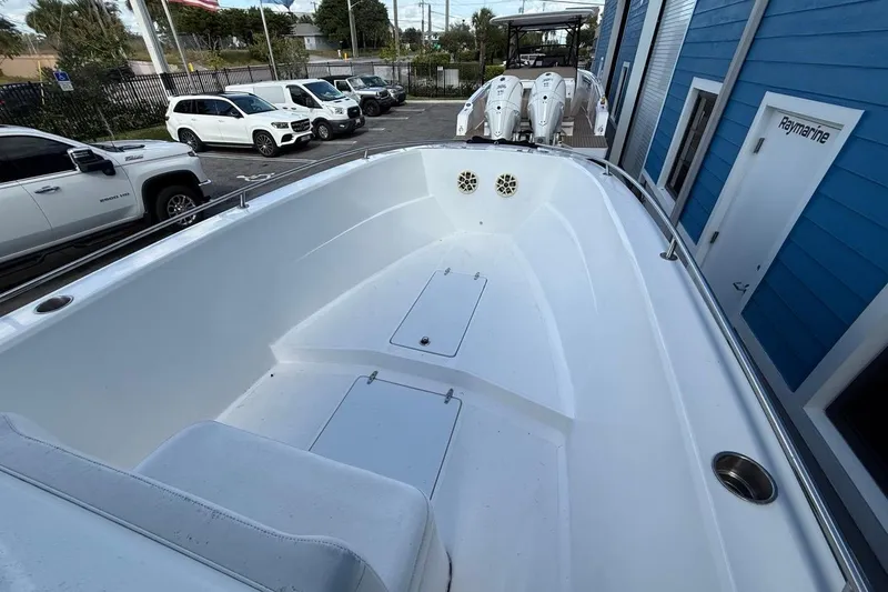 Slide: The Image of 2002 Monza 26 boat interior with white seating and storage compartments. - 10