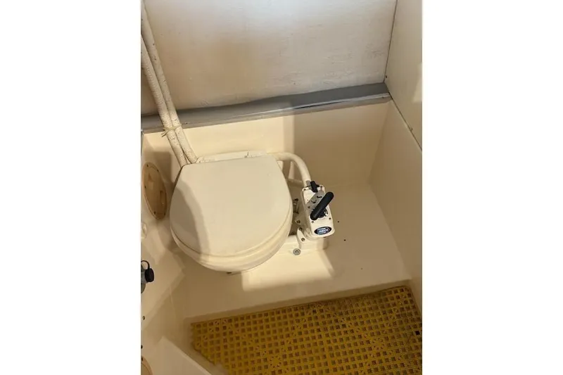 Slide: The Image of Boat toilet in a 2002 Monza 26, featuring manual flush system. - 15