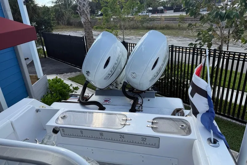 Slide: The Image of 2002 Monza 26 boat with dual Suzuki outboard motors and nautical flag. - 5