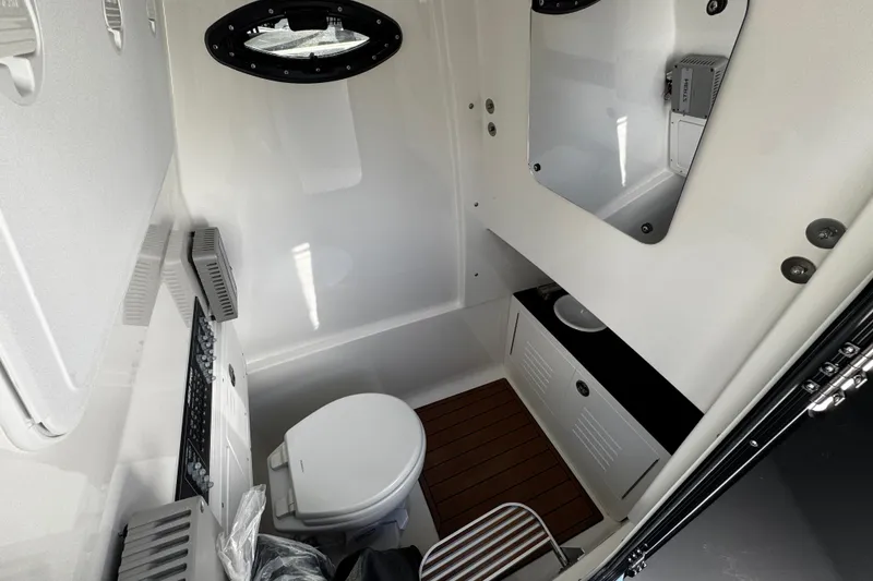 Slide: The Image of Interior of 2026 Sea Pro 292 DLX boat bathroom with toilet and sink. - 11
