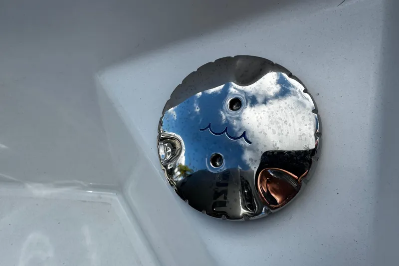 Slide: The Image of Chrome detail on 2026 Sea Pro 292 DLX boat, reflecting sky and surroundings. - 14