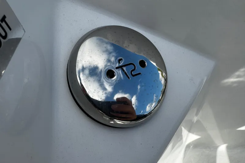 Slide: The Image of Chrome detail on 2026 Sea Pro 292 DLX boat, reflecting sky and surroundings. - 15