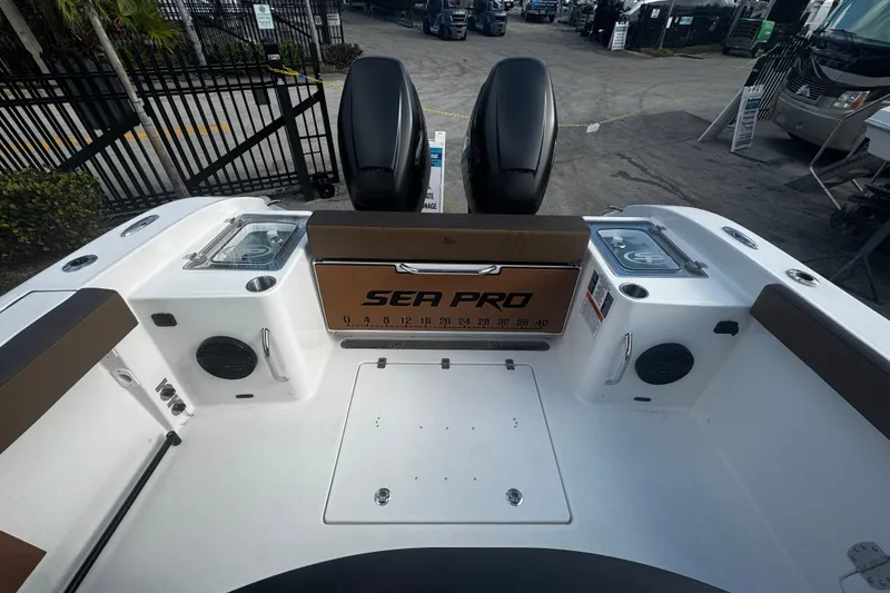 Slide: The Image of 2026 Sea Pro 292 DLX boat interior with dual engines and seating area. - 2