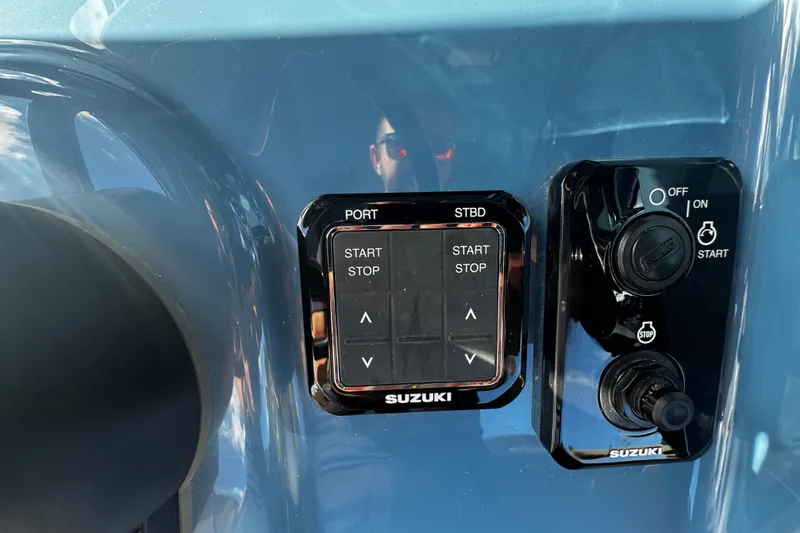 Slide: The Image of Control panel of 2026 Sea Pro 292 DLX boat with Suzuki start-stop buttons. - 23