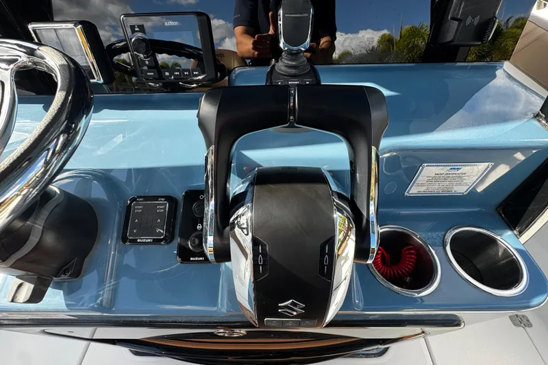 Slide: The Image of 2026 Sea Pro 292 DLX boat dashboard with Suzuki controls and audio system. - 25