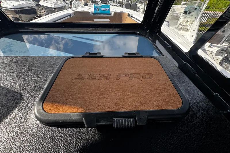 Slide: The Image of 2026 Sea Pro 292 DLX boat dashboard with branded cover, surrounded by other boats. - 28