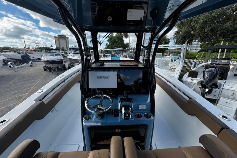 Slide: The Image of 2026 Sea Pro 292 DLX boat interior with steering console and Simrad display. - 5