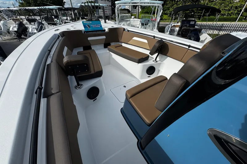 Slide: The Image of 2026 Sea Pro 292 DLX boat interior with brown seating and modern design. - 6
