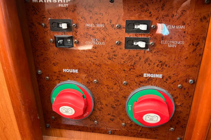 Slide: The Image of Control panel of 2009 Mainship Pilot 31 boat with switches and dials. - 12