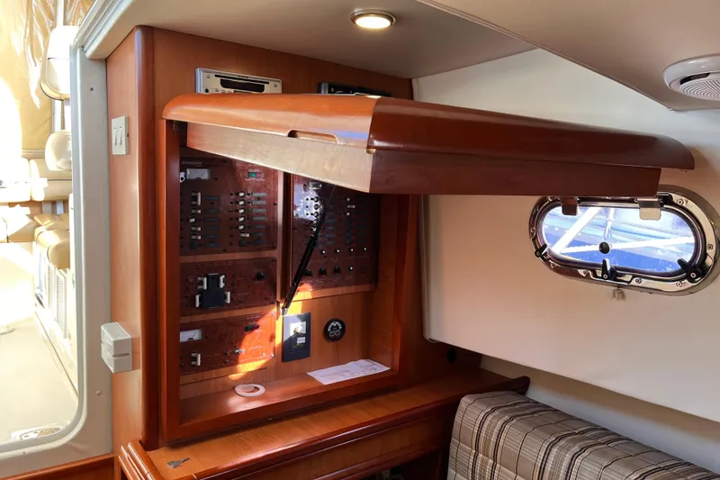Slide: The Image of 2009 Mainship Pilot 31 interior with control panel and porthole window. - 15